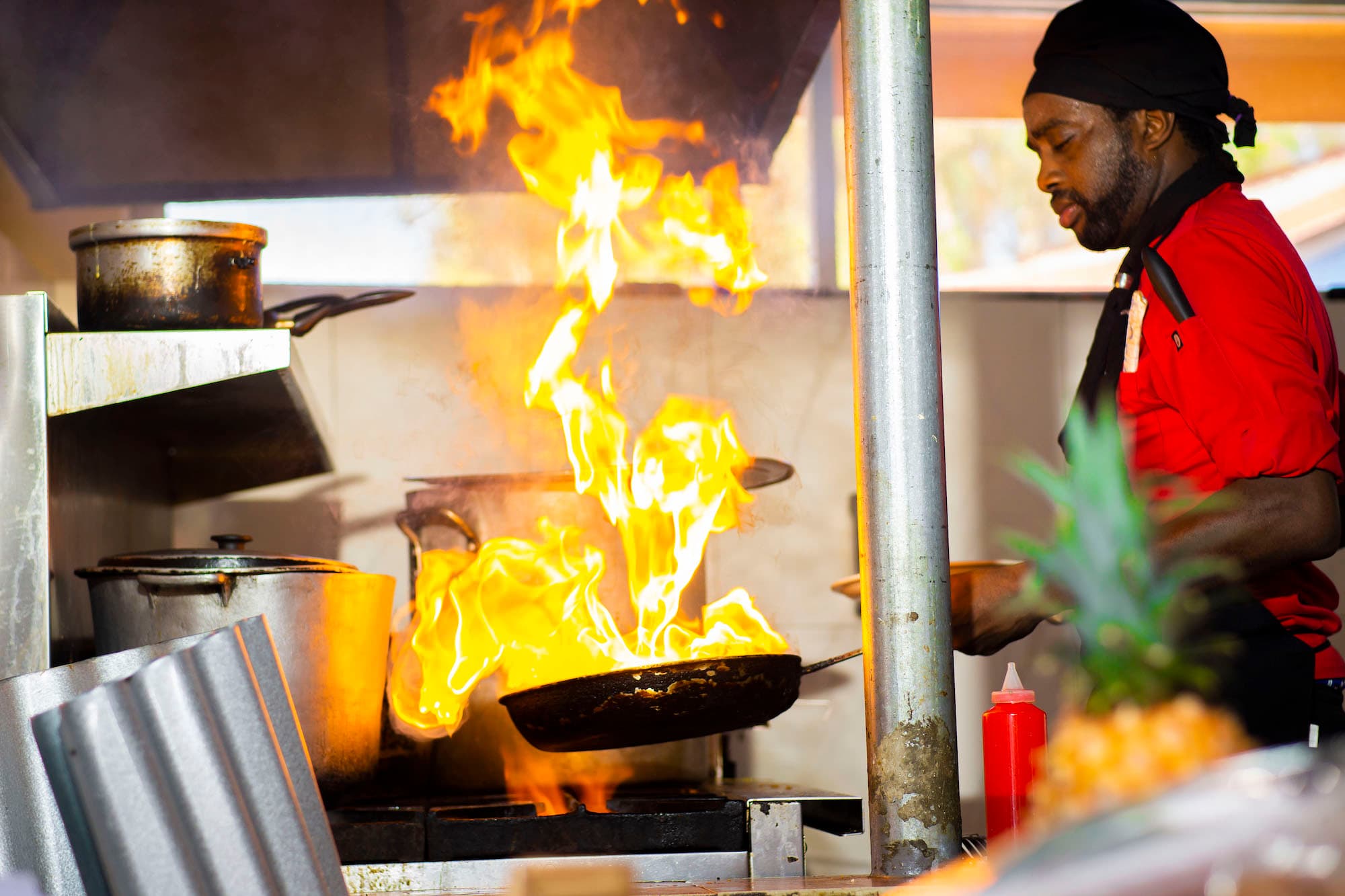 Chef cooking over an open flame at Beyond Sunset Smoke Grill